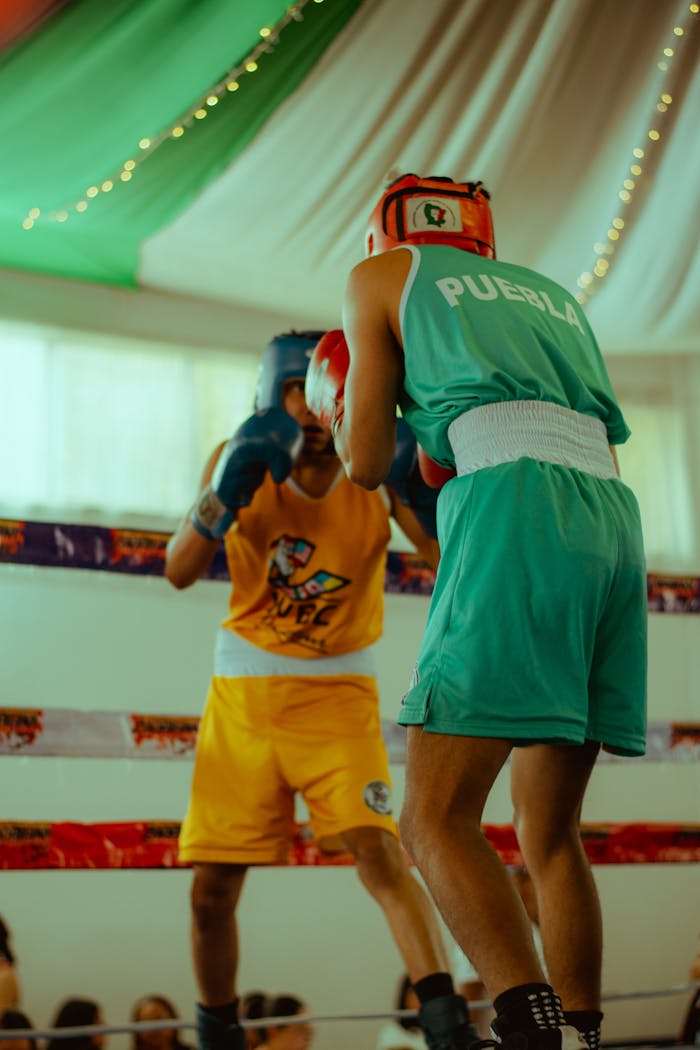 Mastering the First Impression: Your intriguing post title goes here Boxers in colorful gear engage in a lively indoor match, showcasing skill and determination.